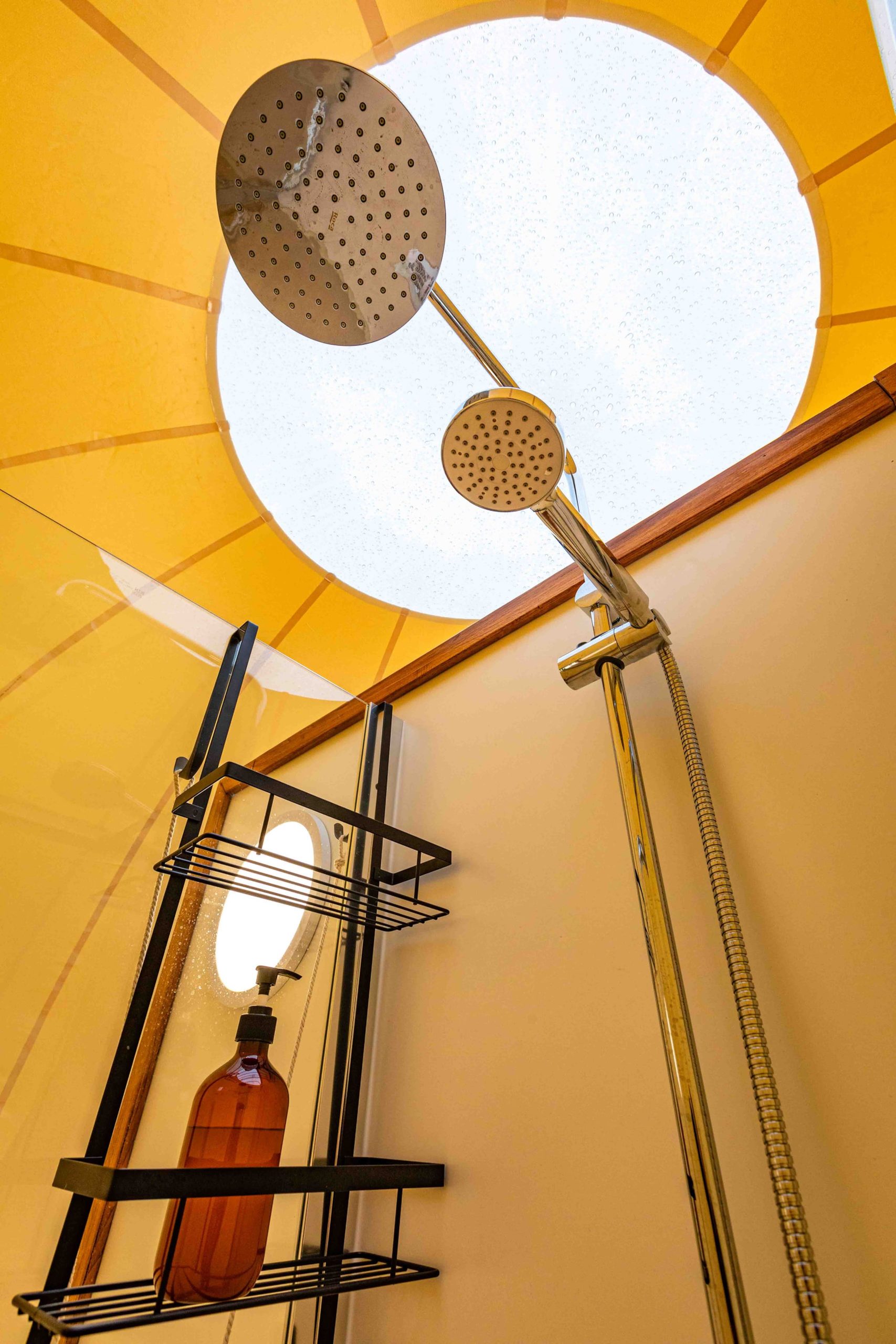 Queen bed beneath the transparent dome roof, open to the daytime sky